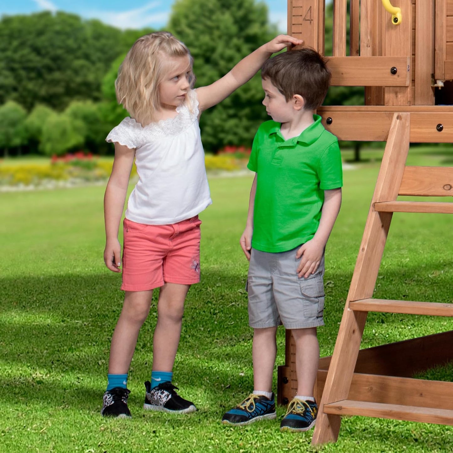 Backyard Discovery Scenic Heights Elevated Cedar Wooden Kids Playhouse with Play Kitchen, Wrap-Around Deck, Toy Storage Bench, Saloon-Style Doors, Ladder, Stairs, and Growth Chart for Outdoor Play